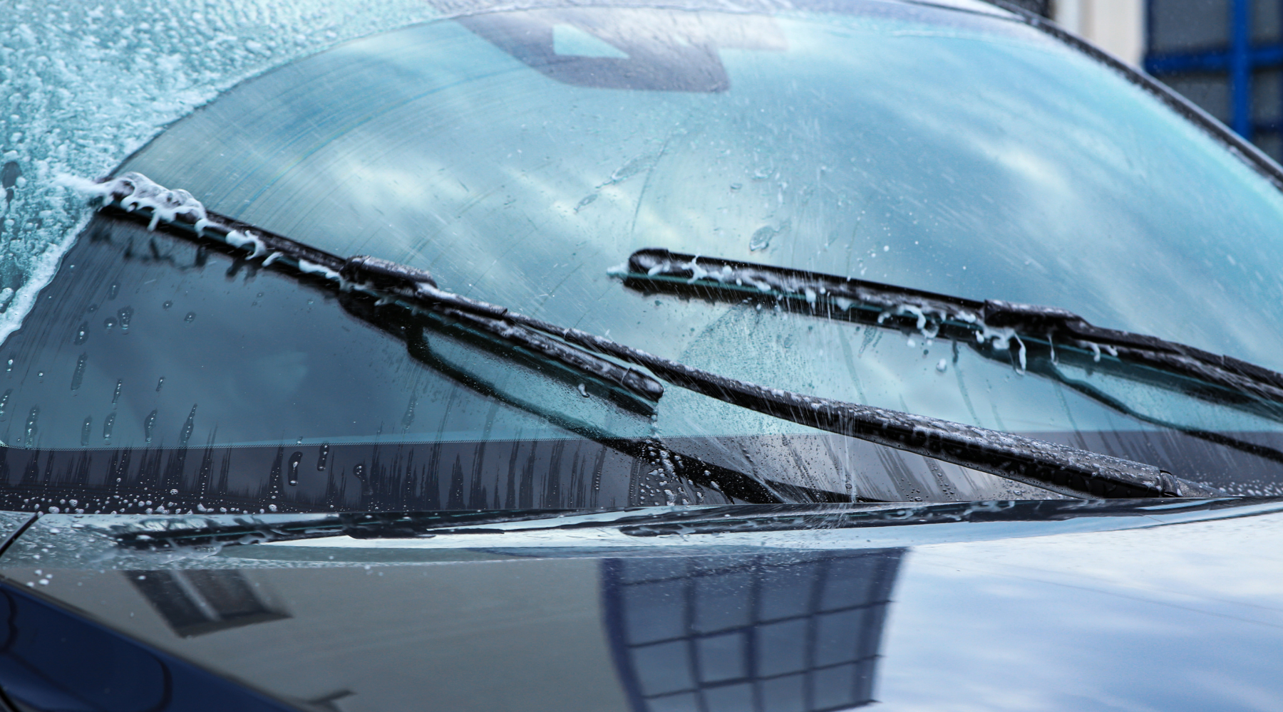 car windshield wipers covered in soap