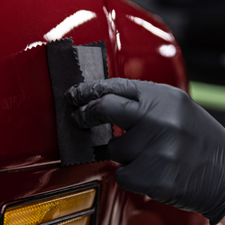 Applying ceramic coating on a red car