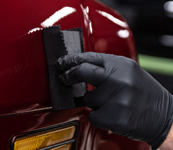 Applying ceramic coating on a red car