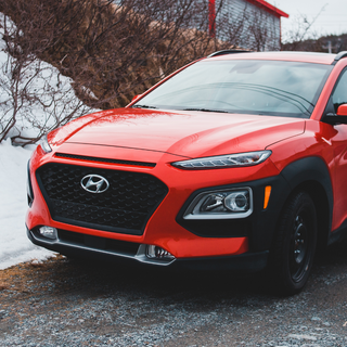 A spotless car against a snowy backdrop, demonstrating proper winter car care