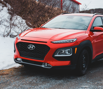 A spotless car against a snowy backdrop, demonstrating proper winter car care