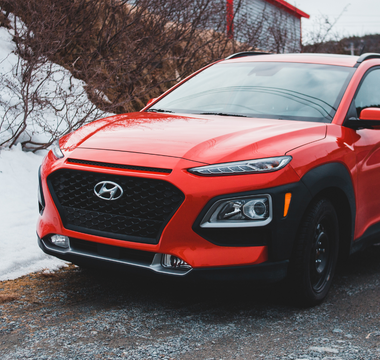 A spotless car against a snowy backdrop, demonstrating proper winter car care