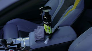 Applying AutoManiacs Interior Cleaner on cloth car seats