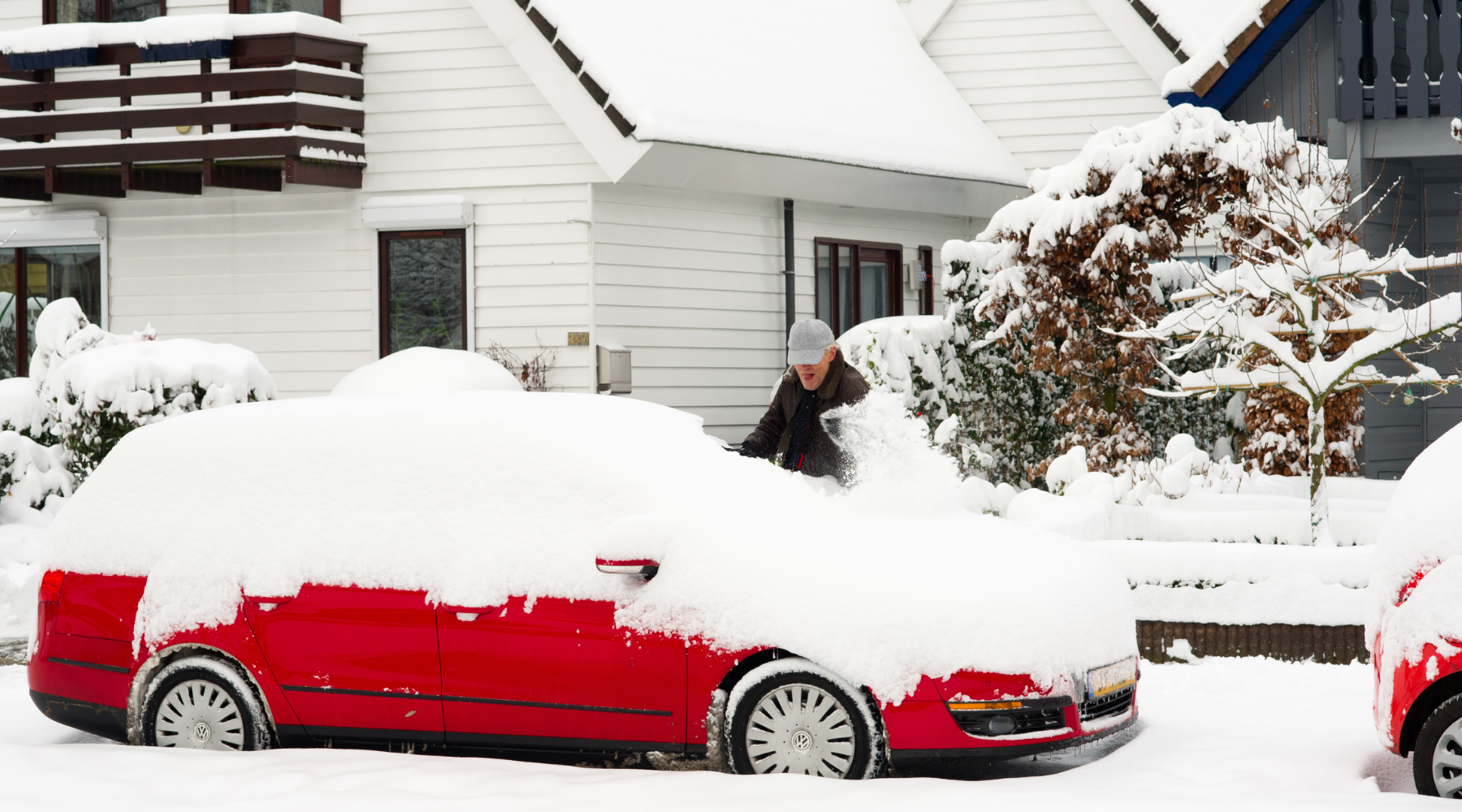 red vehicle covered in snow