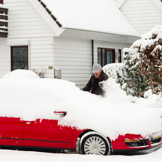 red vehicle covered in snow