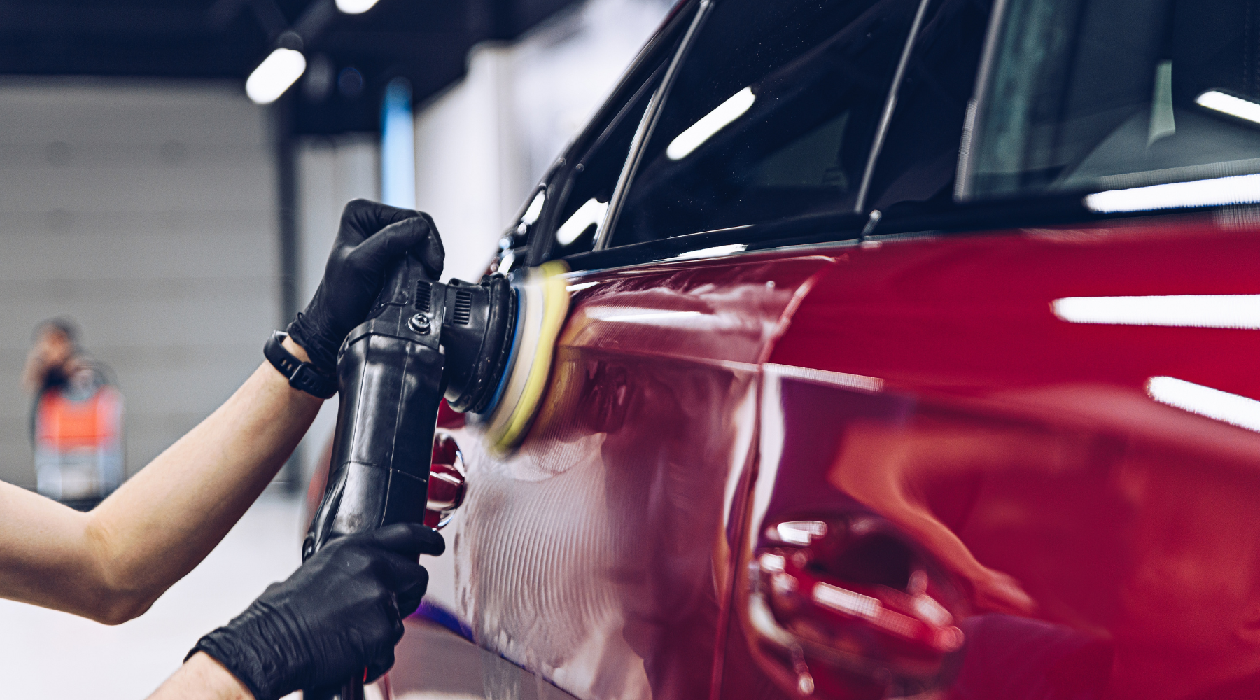 Professional demonstrating swirl removal technique on car paint