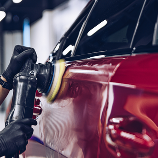 Professional demonstrating swirl removal technique on car paint