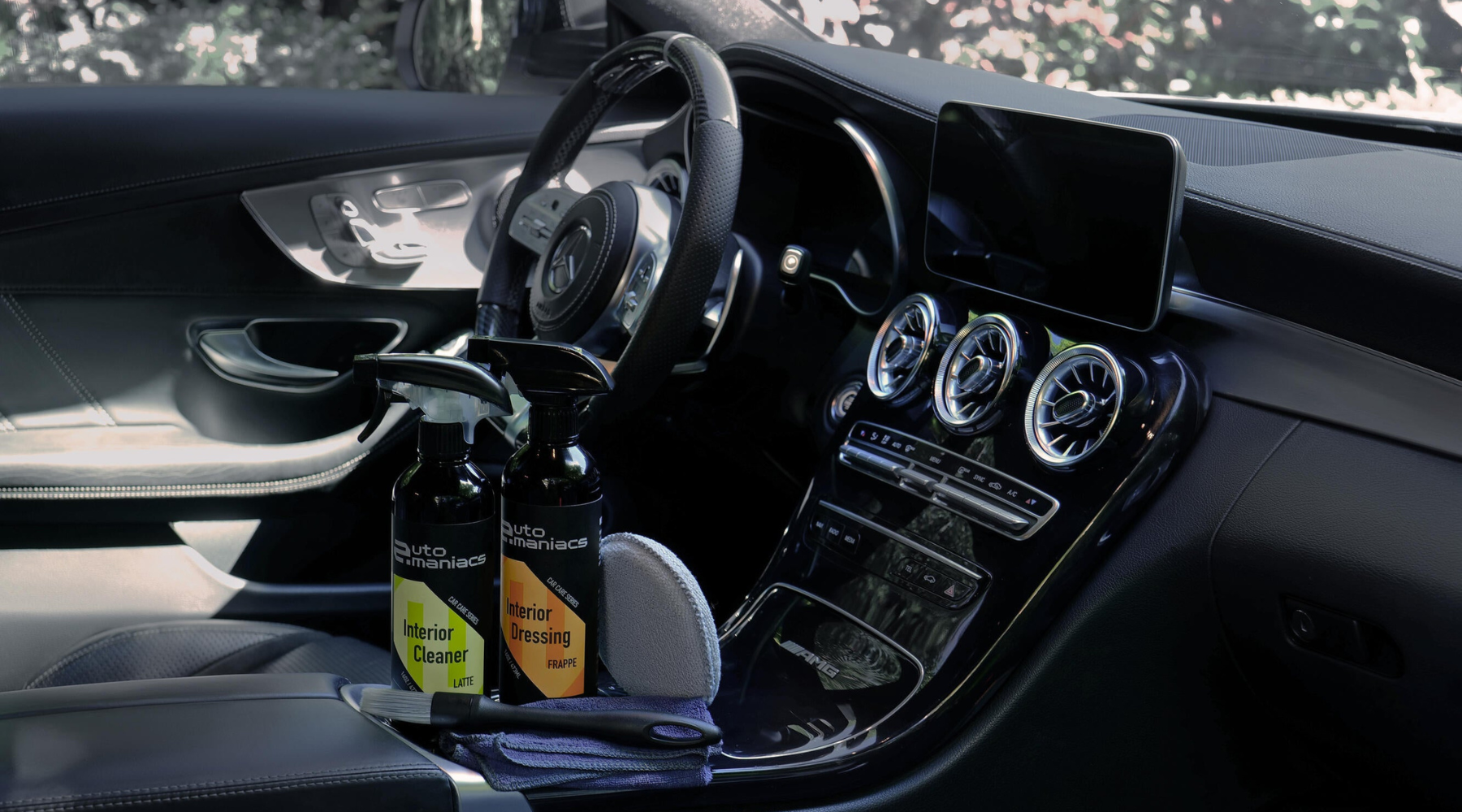 a beautiful car interior with cleaning and detailing products in the console