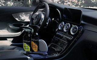 a beautiful car interior with cleaning and detailing products in the console