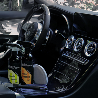 a beautiful car interior with cleaning and detailing products in the console