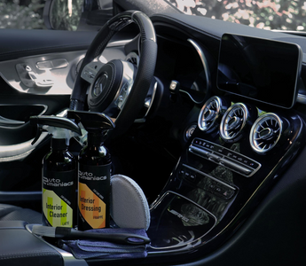 a beautiful car interior with cleaning and detailing products in the console