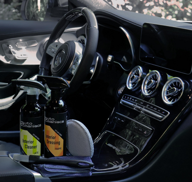 a beautiful car interior with cleaning and detailing products in the console