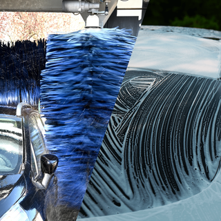 Car being washed with a foam lance vs an automatic car wash tunnel